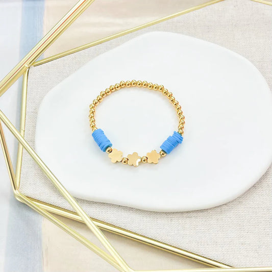 Pulsera dorada con flores y detalles en azul - The Perfect Gift