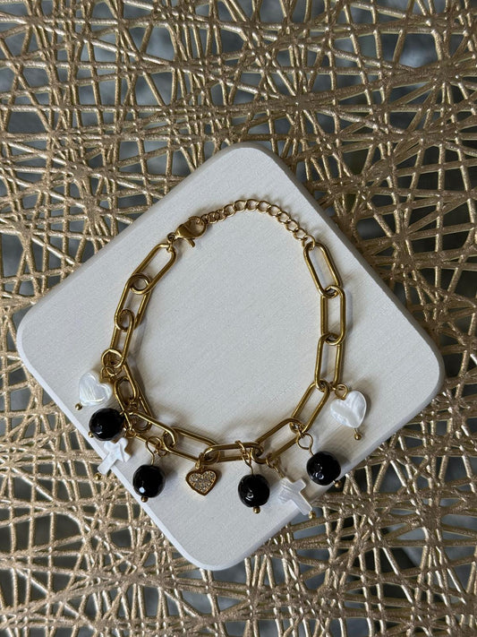 Pulsera dorada con dijes en blanco y negro - The Perfect Gift